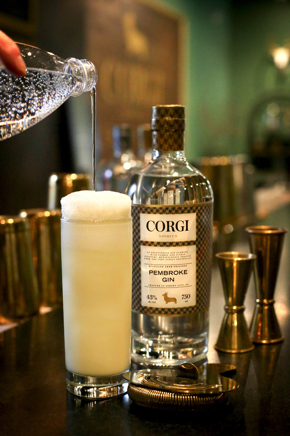 RAMOS GIN FIZZ   2 oz Corgi Spirits Pembroke  1 dash orange blossom water  0.5 oz 1/2 &amp; 1/2  0.5 oz lemon juice  0.5 oz lime juice  0.5 oz simple syrup  1 egg white  1oz seltzer water    In a shaker combine all ingredients excluding the seltzer. Vigorously dry shake (no ice) for 30 seconds. Add ice and vigorously shake for 30 more seconds. Strain cocktail into glass and slowly pour the seltzer water into the mixing glass to release the remaining froth. Gently ease the seltzer water/froth mixture onto the top of the drink and serve.