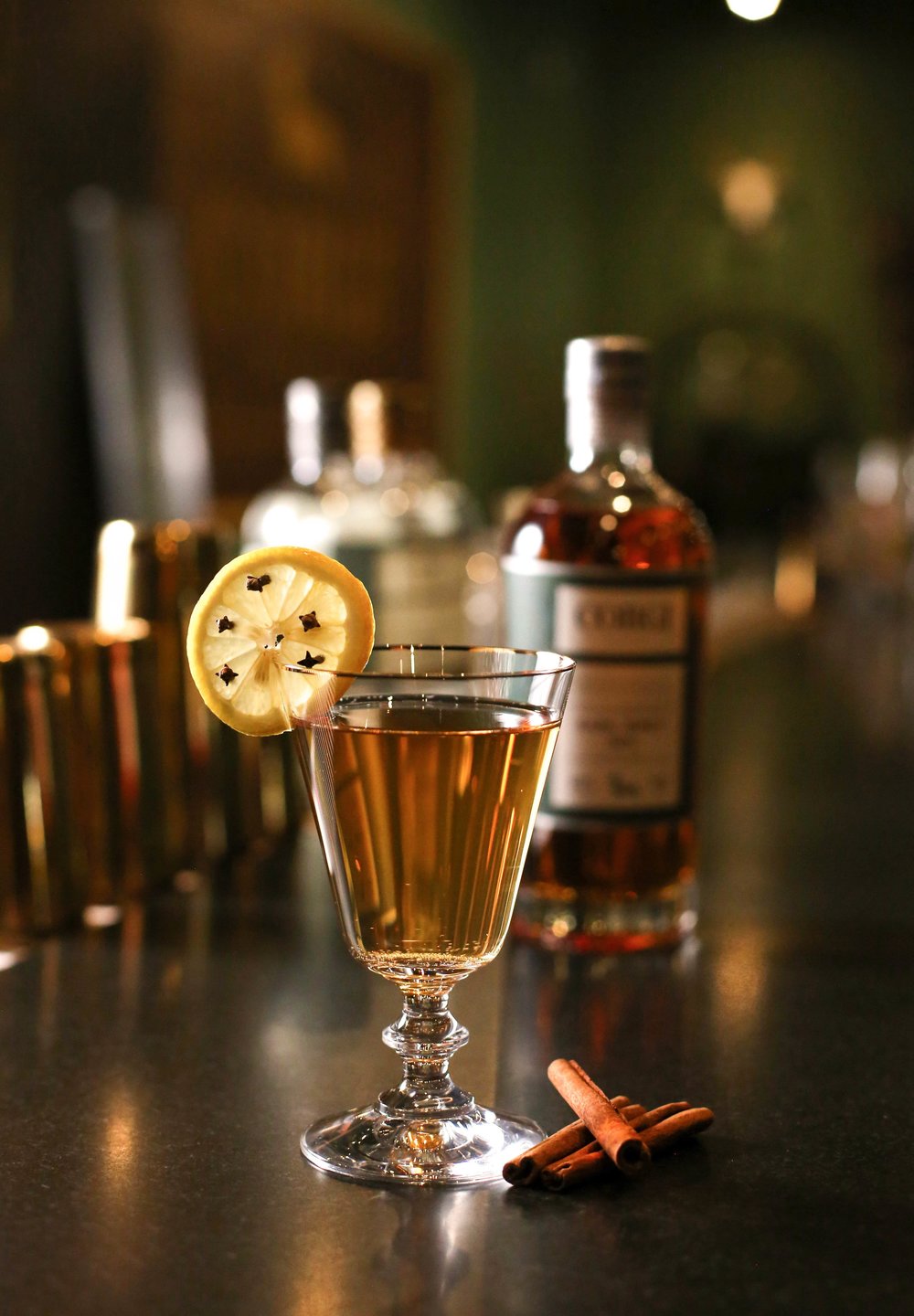 EARL GREY HOT TODDY   2 oz Corgi Spirits Earl Grey Gin  0.5 oz fresh lemon juice  0.75 oz honey syrup (2 parts honey : 1 part water)  3 dashes Angostura bitters  Hot water  Cinnamon stick and lemon wedge for garnish    Combine gin, lemon juice, syrup and bitters in a heatproof mug and add hot water. Stir to combine. Add cinnamon stick and lemon wedge as garnish.