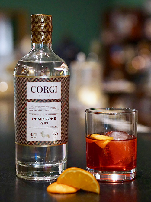 NEGRONI 1 oz Corgi Spirits Pembroke Gin 1 oz Campari 1 oz sweet vermouth Orange peel for garnish Fill a mixing glass with ice, add all ingredients and stir thoroughly until well chilled. Strain over one large ice cube in a rocks glass. Garnish with an orange peel, expressing the oils over the top of the drink.